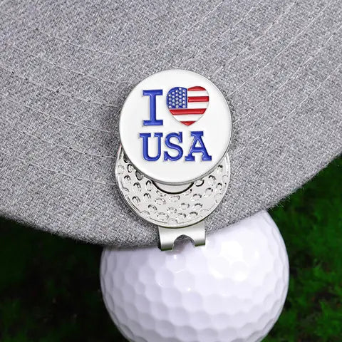Magnetic golf hat clip with ball marker attached to a cap brim
